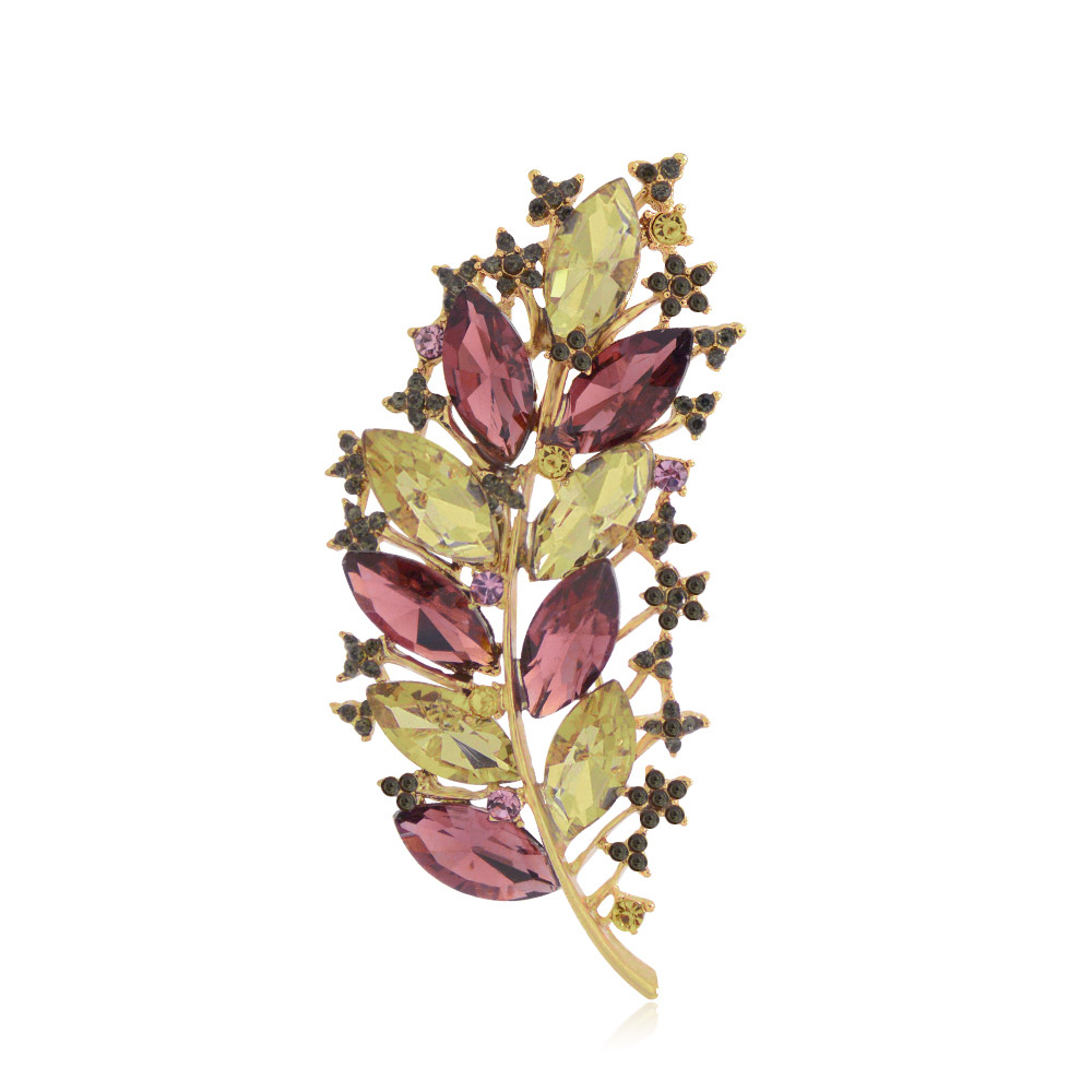 Detailed view of the vintage rhinestone leaf brooch with multi-colored crystals
