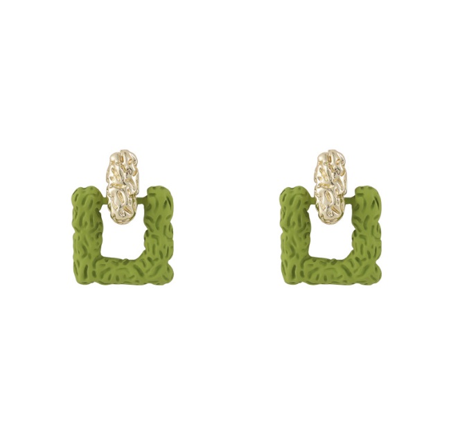 A detailed view of green textured square earrings with gold accents