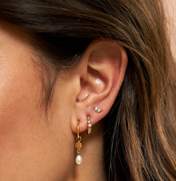 Model wearing the gold plated fancy drop earring with a pearl